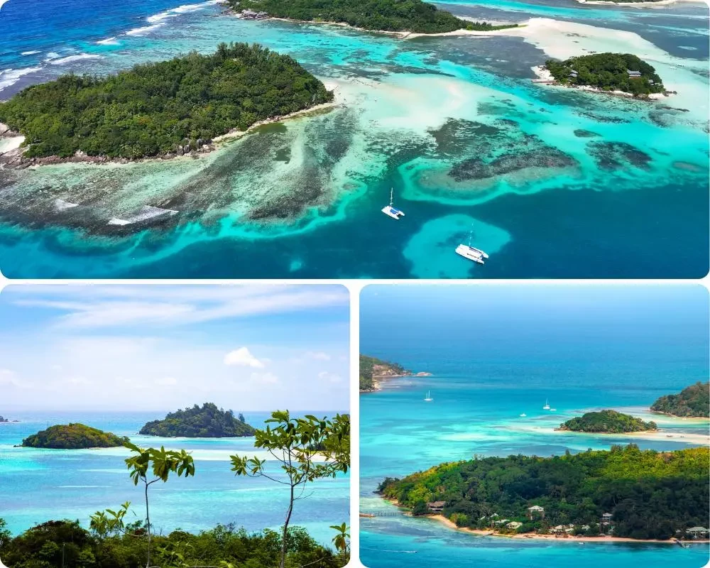 Vue aérienne du parc national marin de Sainte-Anne aux Seychelles, avec ses îlots tropicaux, ses lagons turquoise, ses récifs coralliens et des catamarans au mouillage dans une eau cristalline.